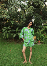 Woman wearing Azurina Green Fish Two Fish print cotton shorts set, luxury resortwear