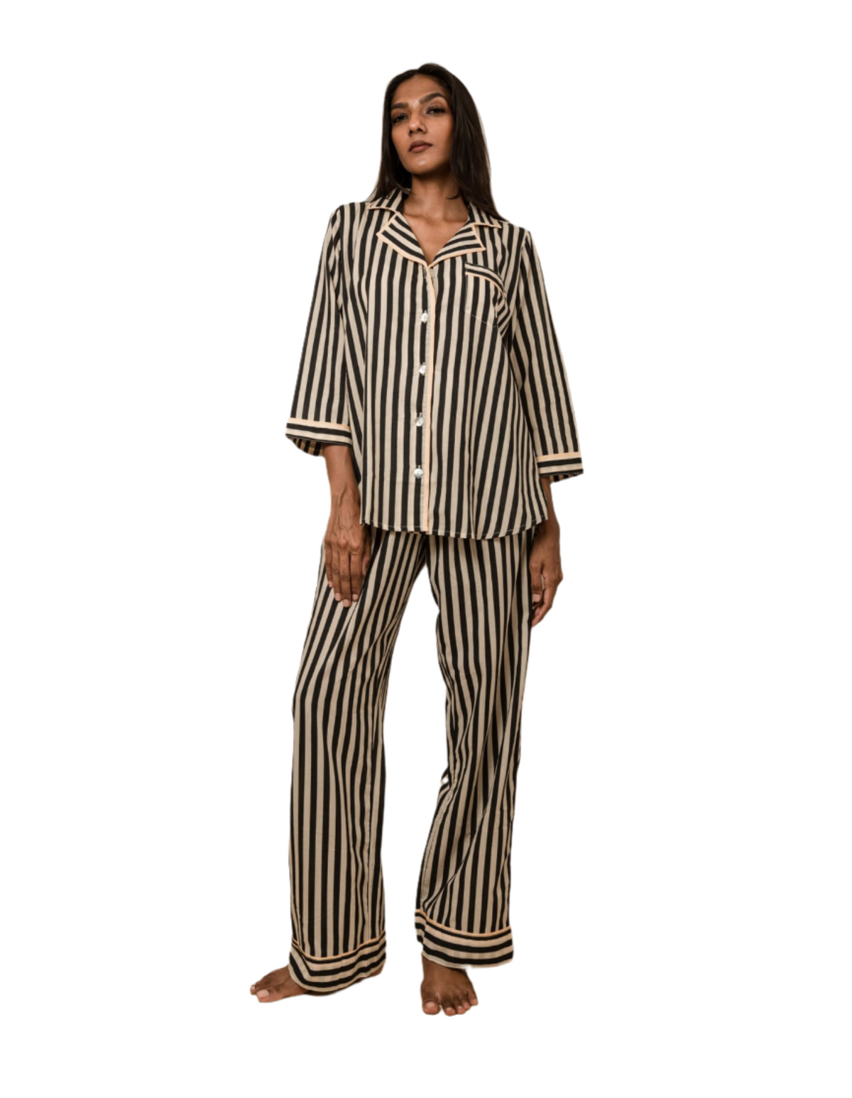 Woman wearing Black Satori print button-down pajama set with beige piping, premium cotton sleepwear