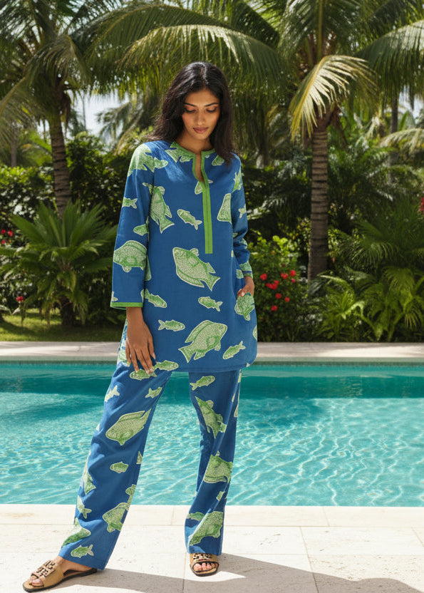 Woman wearing blue and white fish print cotton tunic set for luxury resortwear aesthetic