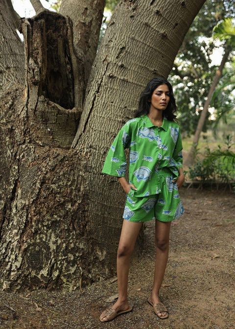 Woman wearing Azurina Green Fish Two Fish print cotton shorts set, luxury resortwear