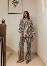 Woman wearing Black Satori print button-down pajama set with beige piping, premium cotton sleepwear